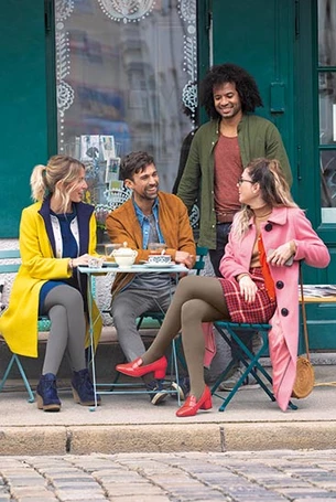 Image of men and women sat at a table wearing compression stockings