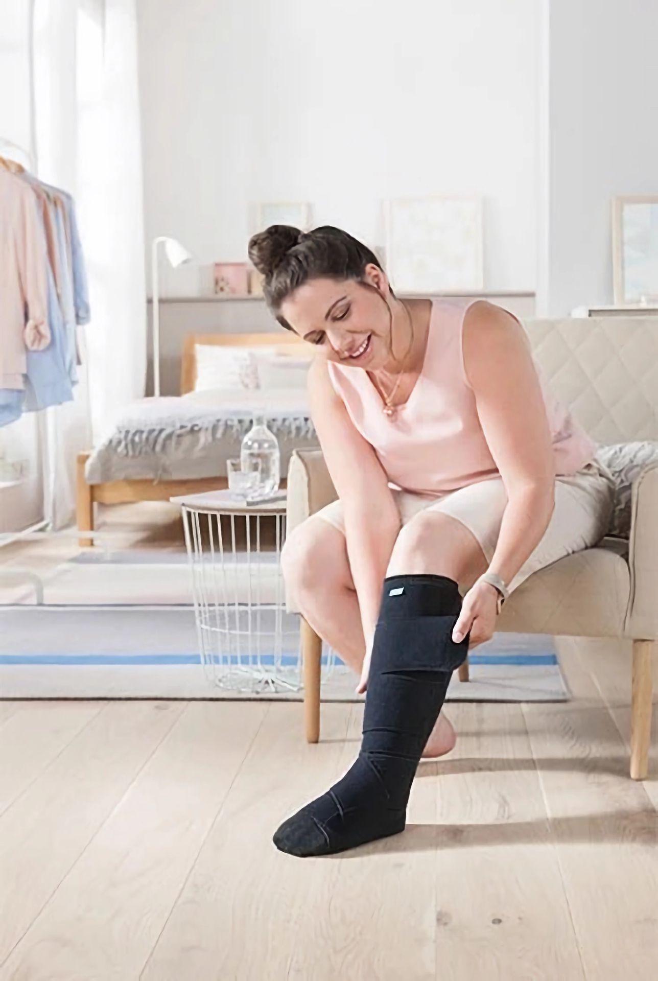 Woman donning compression hosiery Woman donning compression hosiery