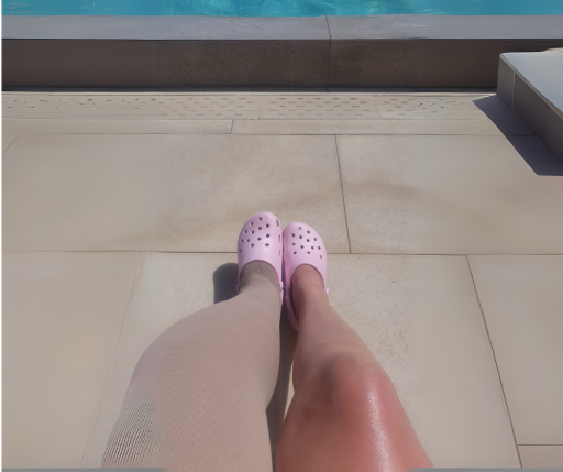Women's legs, one wearing compression by the pool
